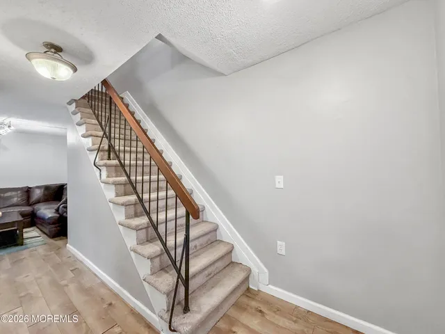a view of staircase with white walls and a window