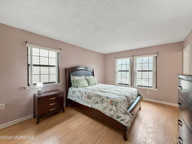a bedroom with a bed and large window