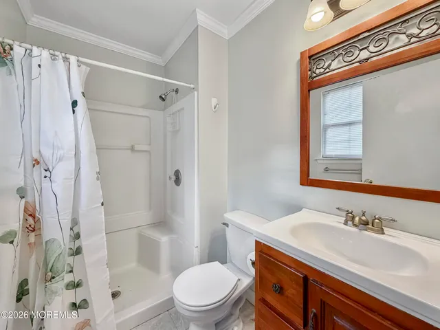 a view of a hallway with wooden floor and entryway