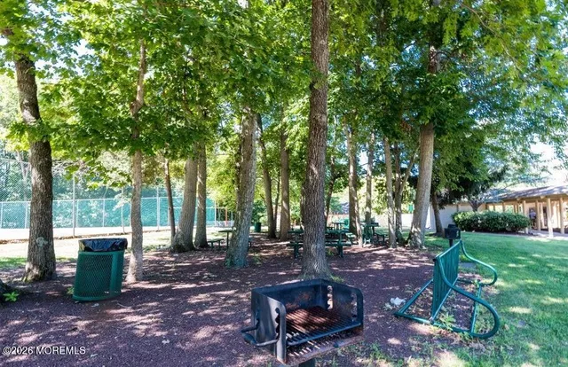 a view of a patio with table and chairs under an umbrella