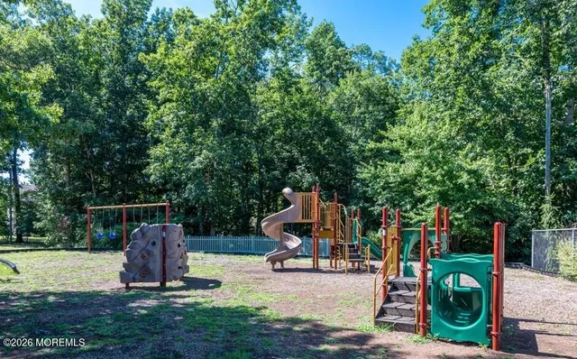 a view of a patio with table and chairs potted plants and a large tree