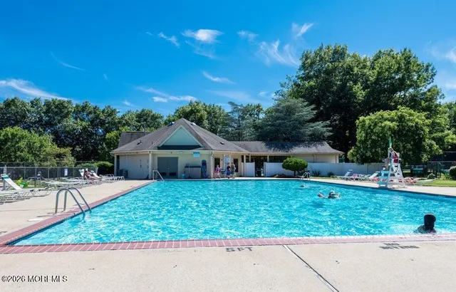 a view of a swimming pool with a patio