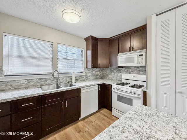 a kitchen with a sink stove and cabinets