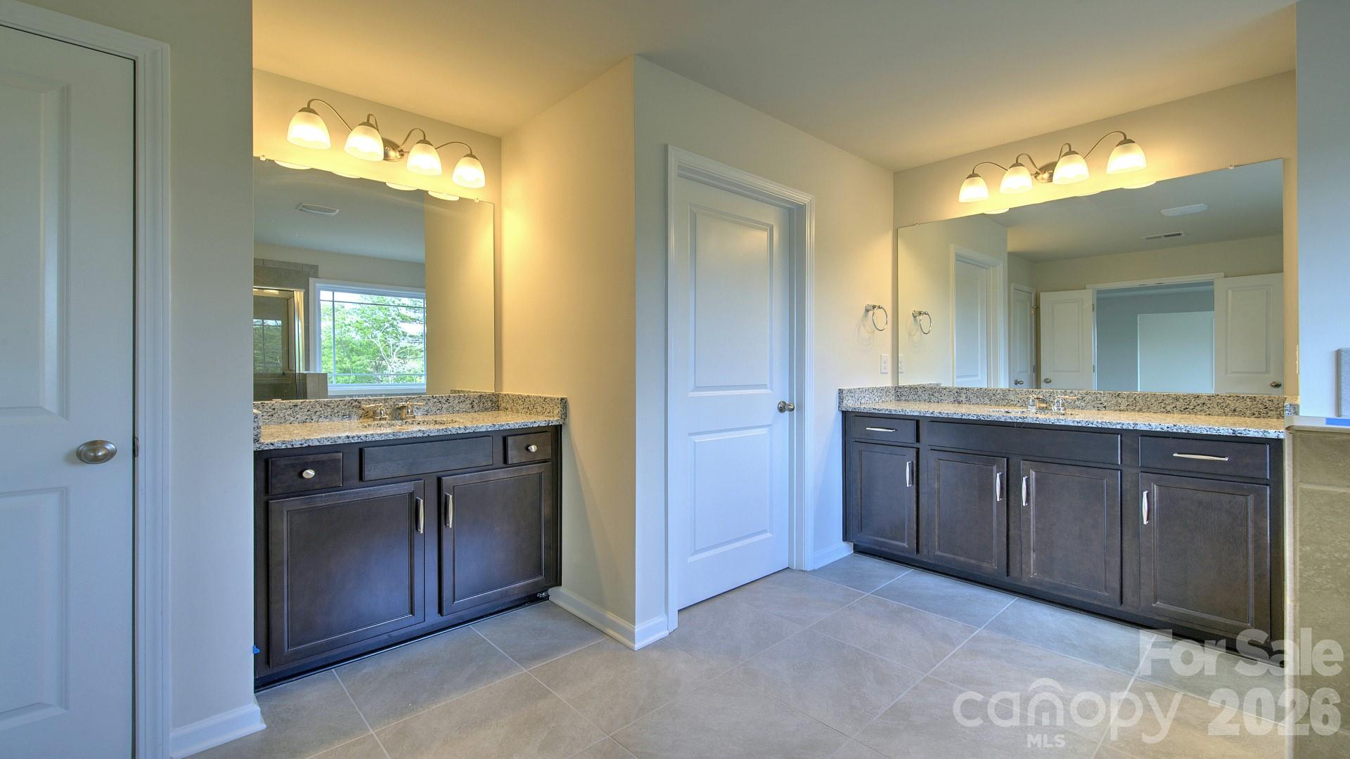 505 River Btm Road Fletcher, NC 28732 - Photo 16 of 20 a bathroom with a granite countertop sink and a mirror