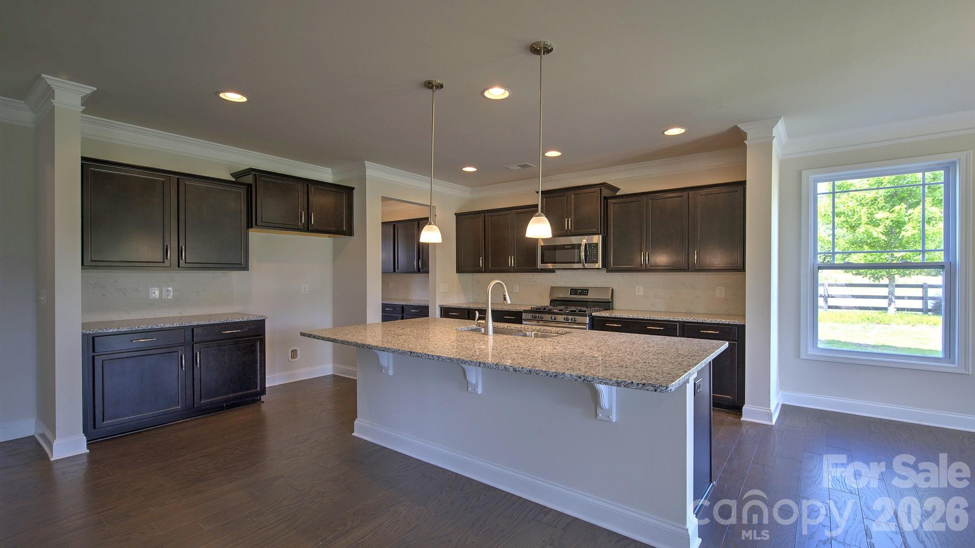 505 River Btm Road Fletcher, NC 28732 - Photo 9 of 20 a large kitchen with stainless steel appliances a large counter top a stove a sink and a refrigerator