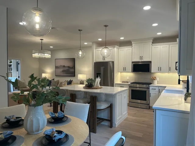 a kitchen with a stove a sink and a refrigerator