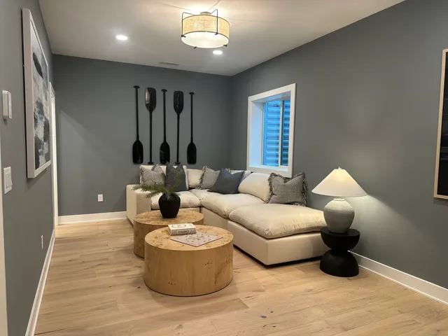 a living room with furniture and a chandelier
