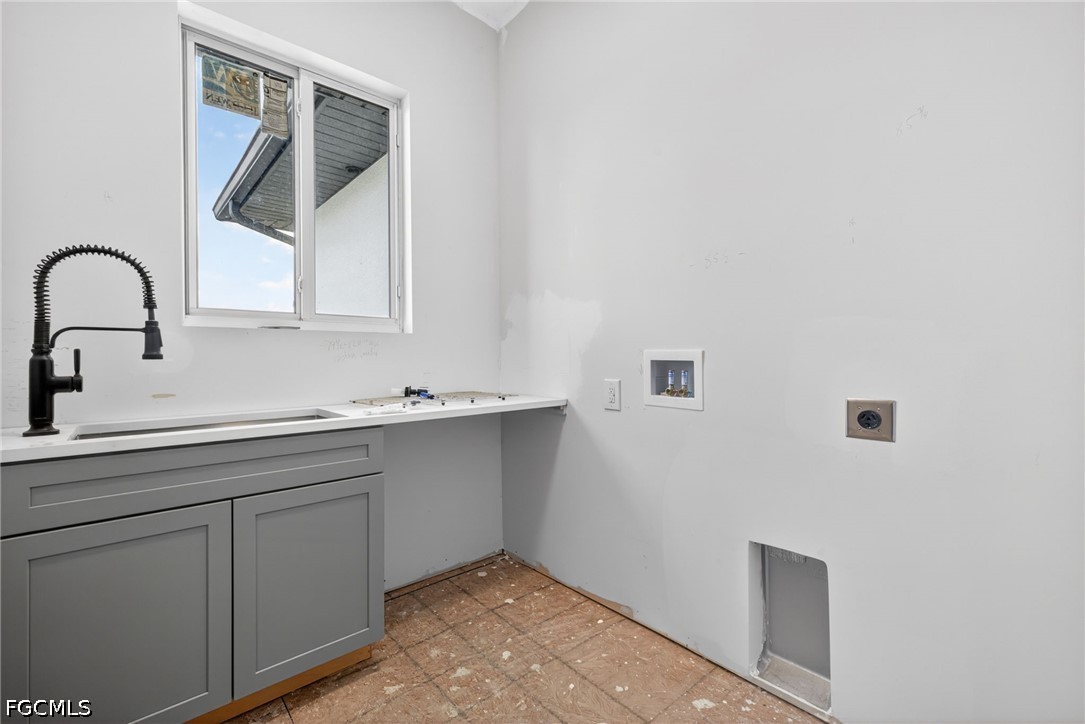 2665 Oil Well Road Naples, FL 34120 - Photo 33 of 40 a close view of a sink and dishwasher in a white cabinet