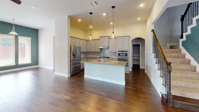 a view of kitchen with cabinets and wooden floor
