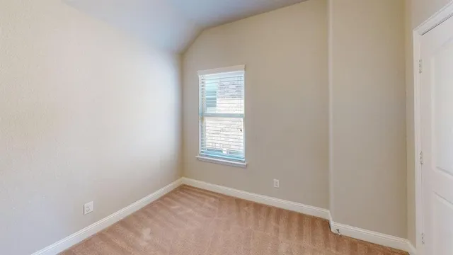 an empty room with windows and entrance