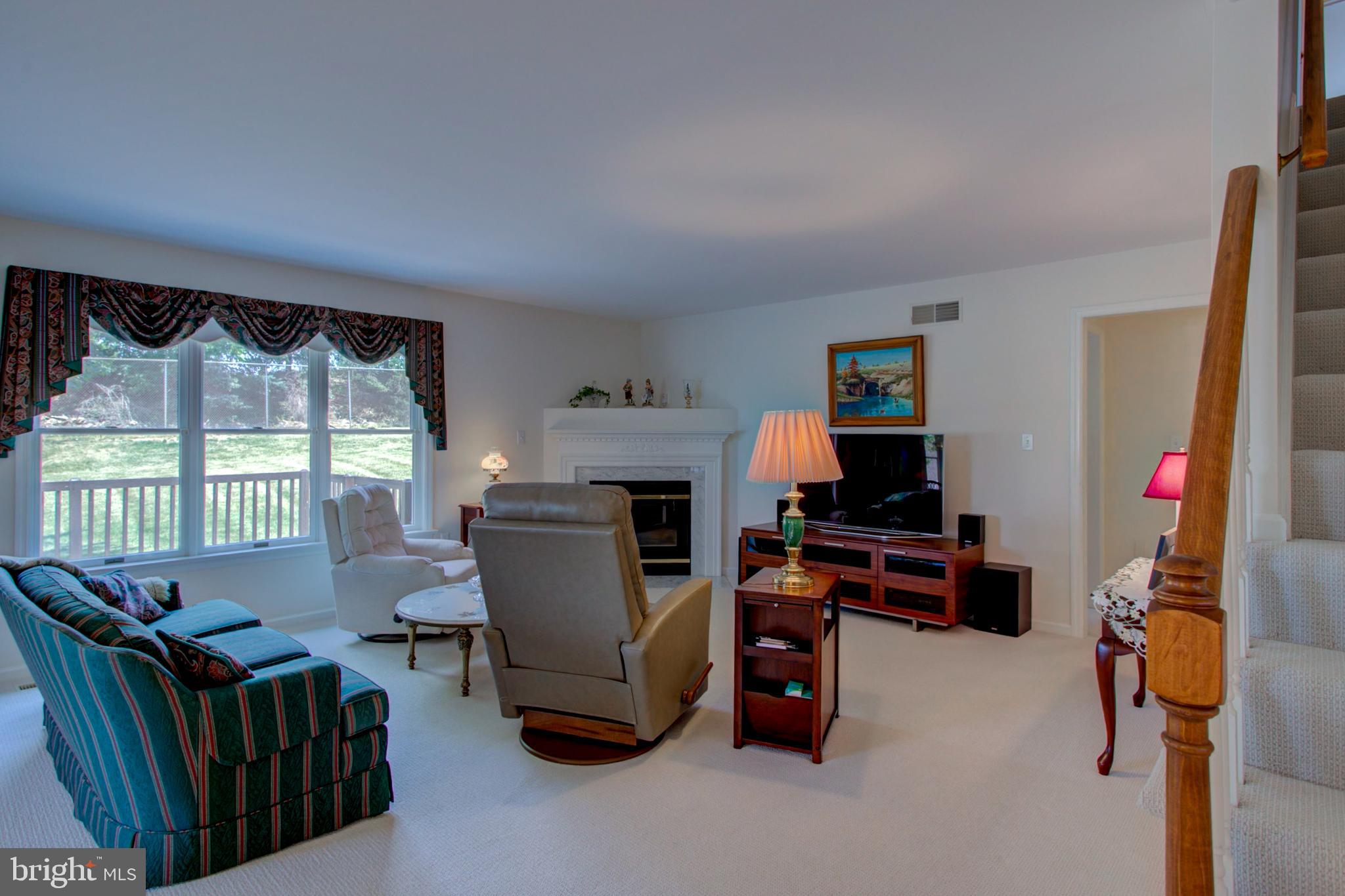 2041 Harrogate Road Lancaster, PA 17601 - Photo 18 of 46 a living room with furniture a flat screen tv and a fireplace