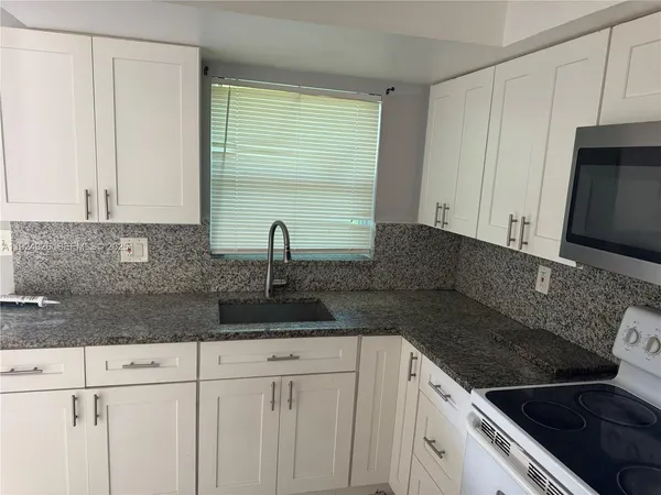 a kitchen with a sink and cabinets