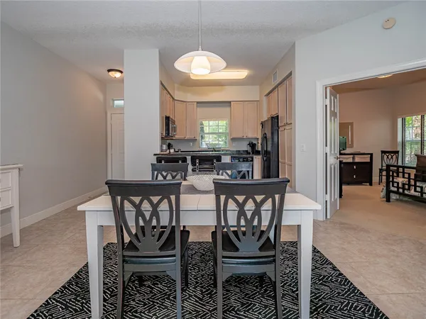 a view of a a dining room with furniture and window