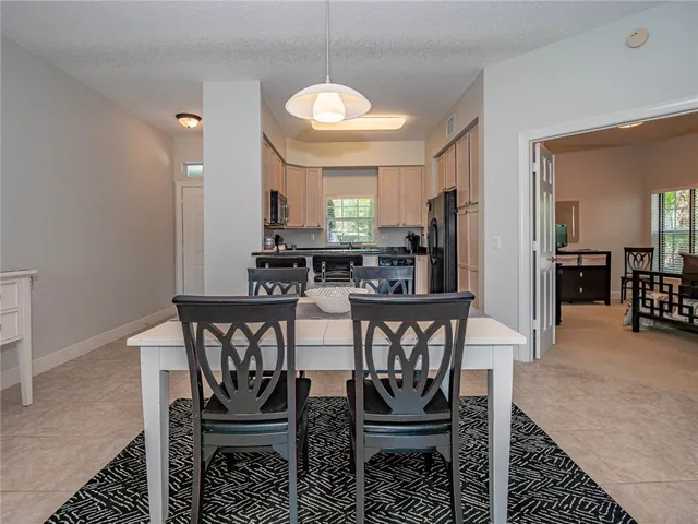 a view of a a dining room with furniture and window