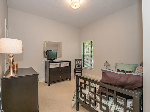 a bedroom with furniture and a dresser