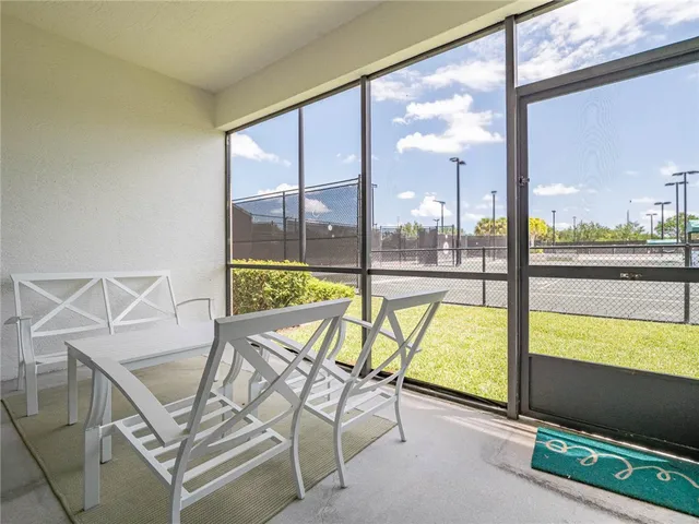 a view of a living room with a floor to ceiling window and floor to ceiling window