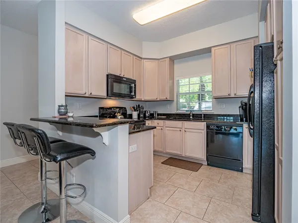 a kitchen with a stove a sink and a refrigerator