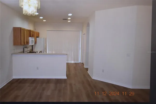 a view of a kitchen with a sink and a mirror
