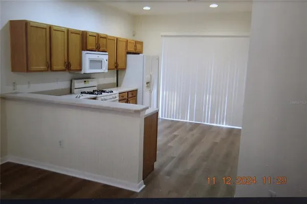 a kitchen with stainless steel appliances a stove refrigerator sink and microwave