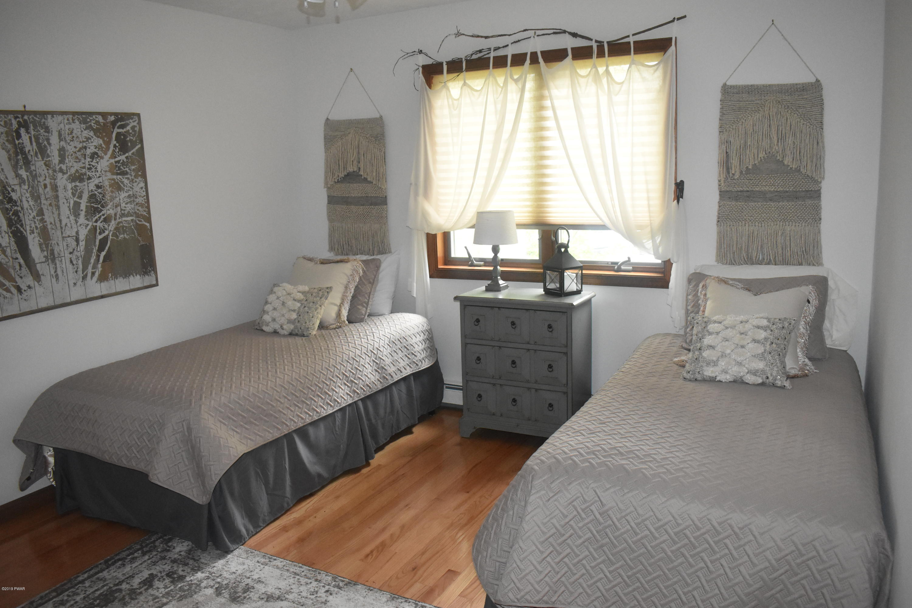 105 Rodeo Drive Hawley, PA 18428 - Photo 13 of 42 a bedroom with a bed and a table