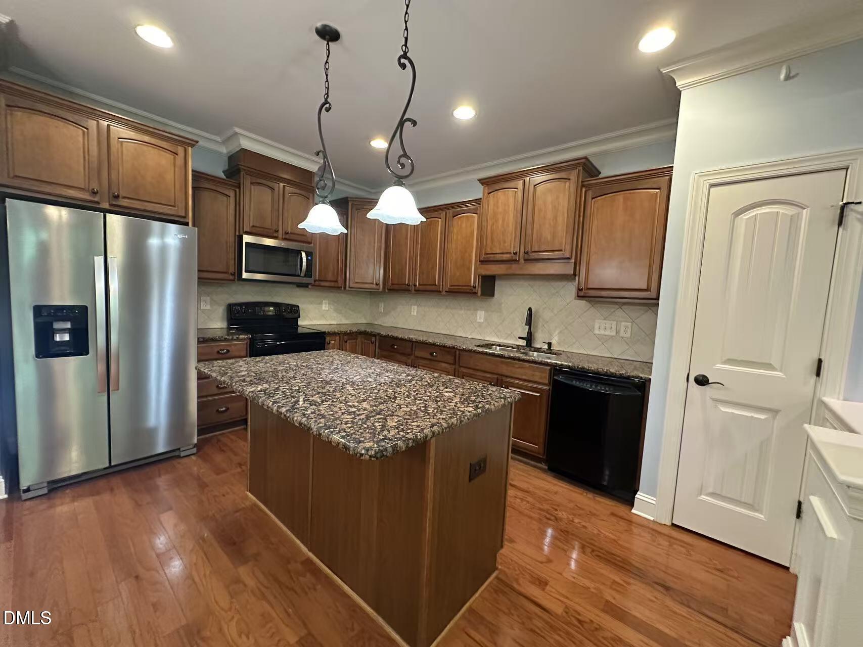 1056 Indigo Ridge Place Cary, NC 27519 - Photo 6 of 33 a kitchen with stainless steel appliances granite countertop a sink stove and refrigerator