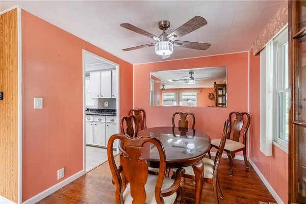 a dining room with furniture and chandelier kitchen view
