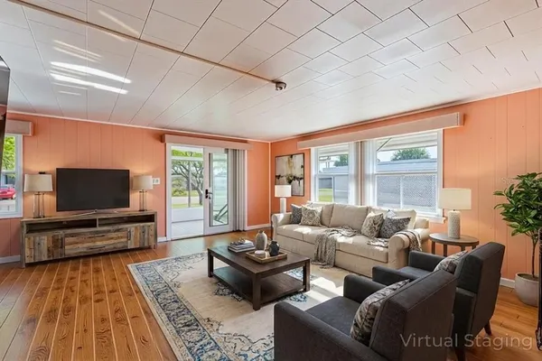 a living room with furniture and a flat screen tv