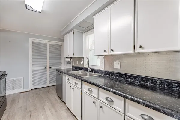 a kitchen with a sink and cabinets