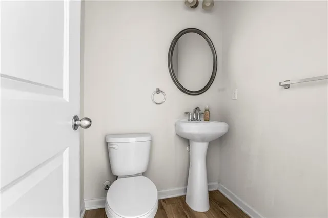 a bedroom with a bed and a flat tv screen on dresser