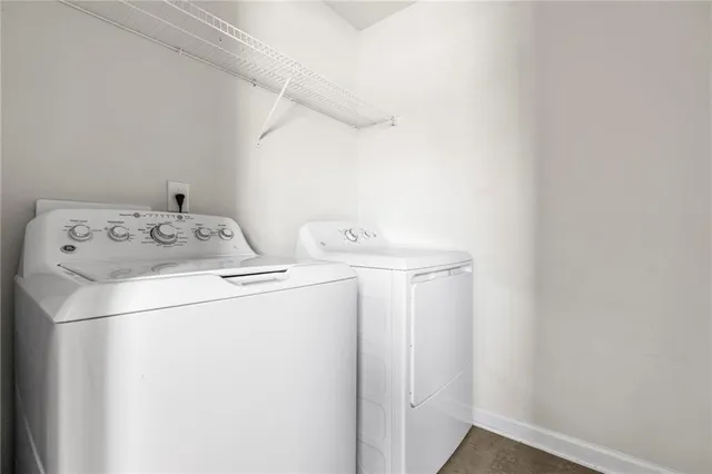 a view of a house with wooden fence