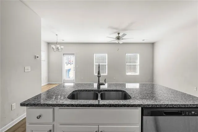 a view of kitchen with cabinets appliances and wooden floor