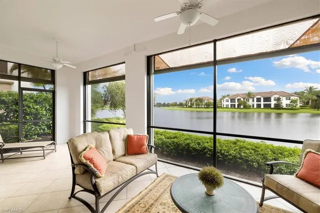 a balcony with furniture and a lake view