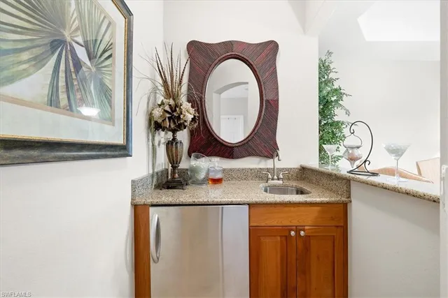 a kitchen with stainless steel appliances granite countertop a stove top oven a sink and dishwasher