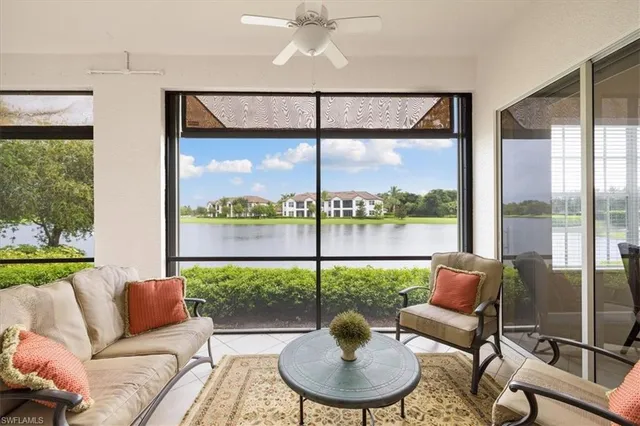 a balcony with furniture and a floor to ceiling window