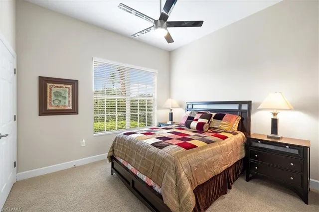 a bedroom with a bed and a lamp