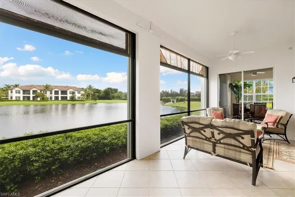 a living room with furniture a flat screen tv and a large window