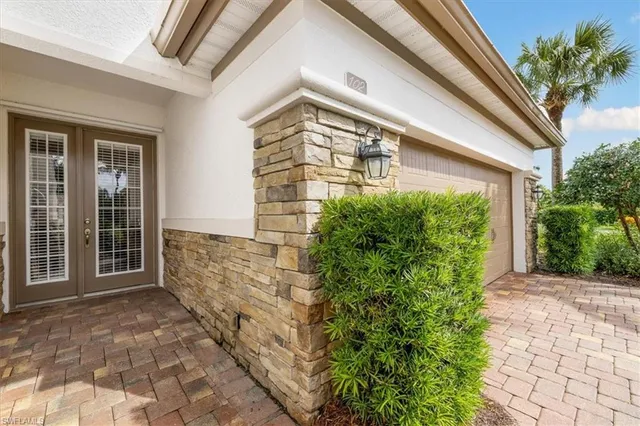 a view of a house with a big yard and potted plants