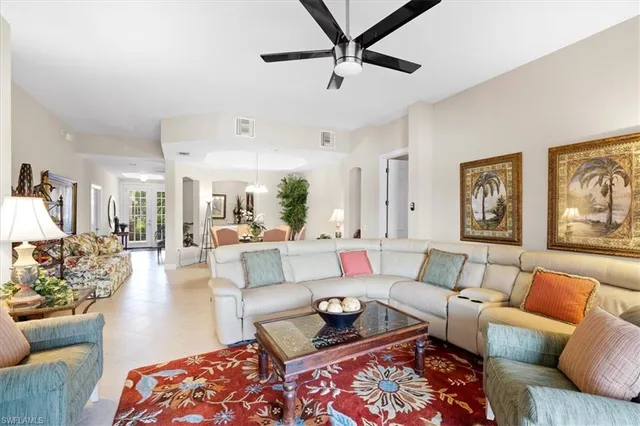 a living room with furniture tv and a large window