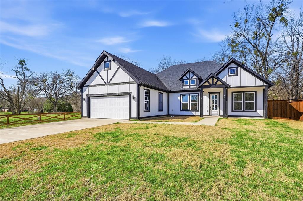 1110 Norris Street Commerce, TX 75428 - Photo 1 of 40 a front view of a house with a garden and yard