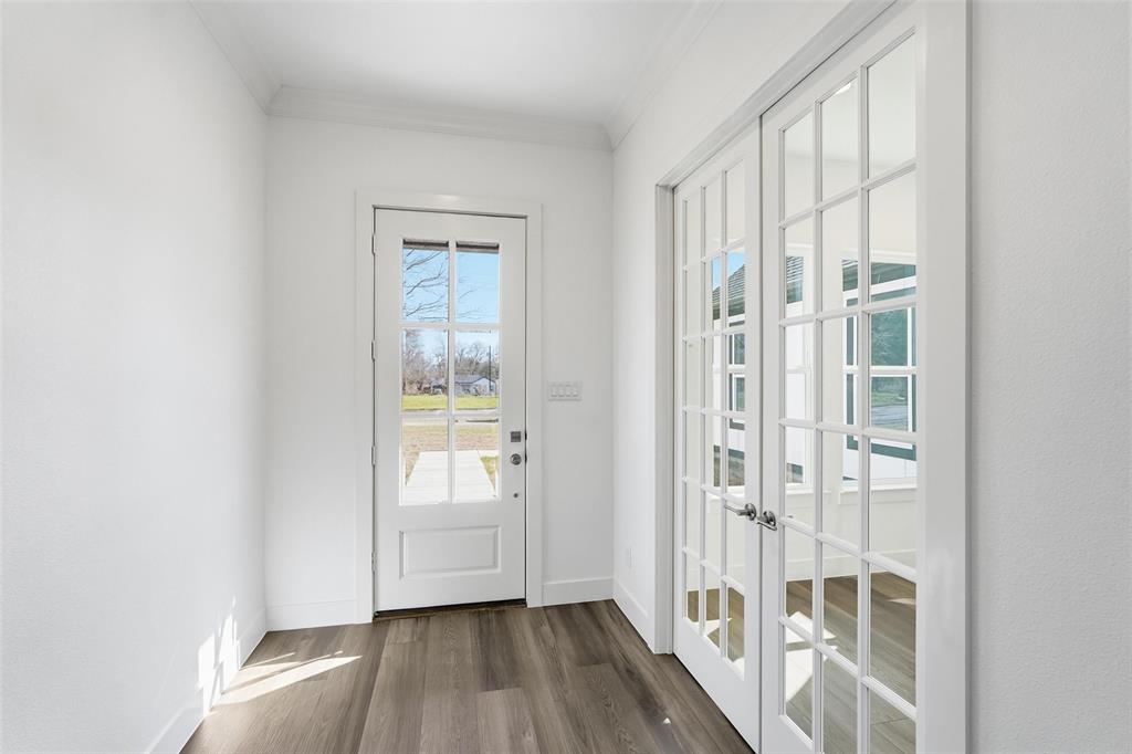 1110 Norris Street Commerce, TX 75428 - Photo 2 of 40 a view of an entryway with wooden floor and door