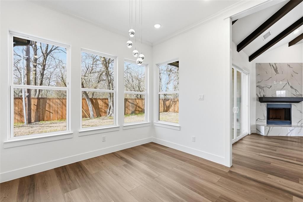 1110 Norris Street Commerce, TX 75428 - Photo 23 of 40 a view of an empty room with wooden floor and a window