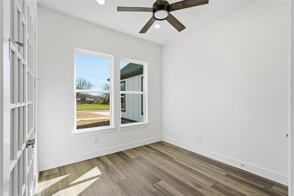 1110 Norris Street Commerce, TX 75428 - Photo 3 of 40 a view of empty room with wooden floor and fan