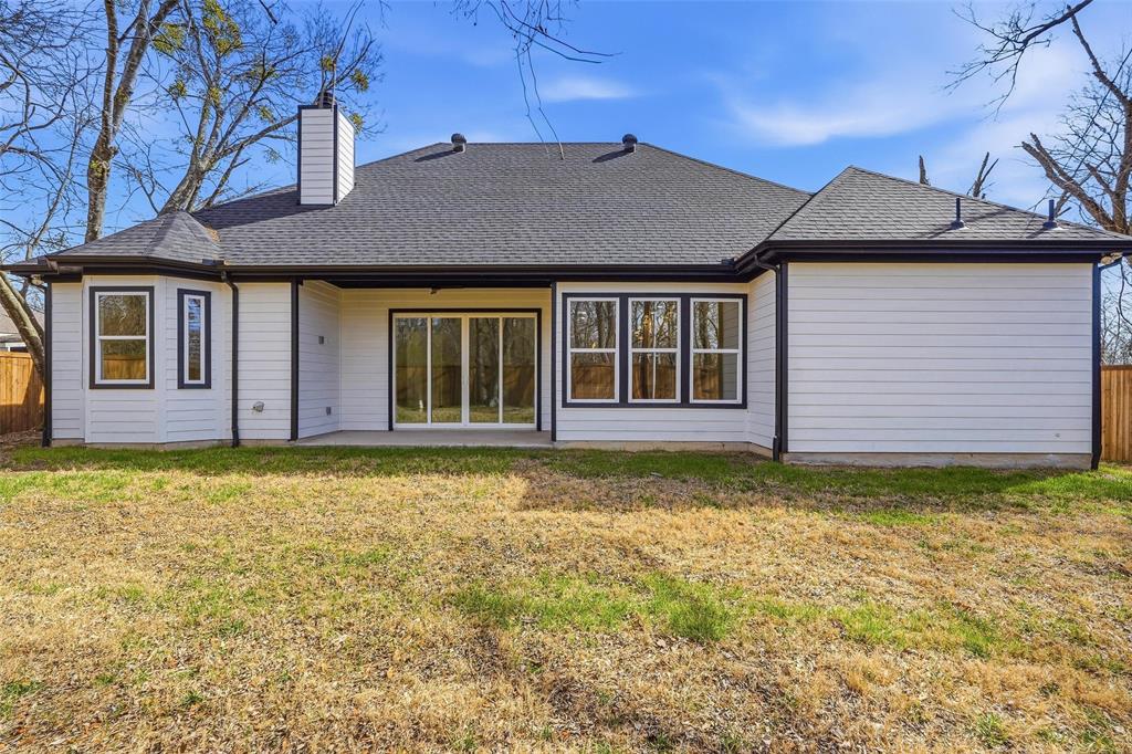 1110 Norris Street Commerce, TX 75428 - Photo 38 of 40 a front view of a house with a garden