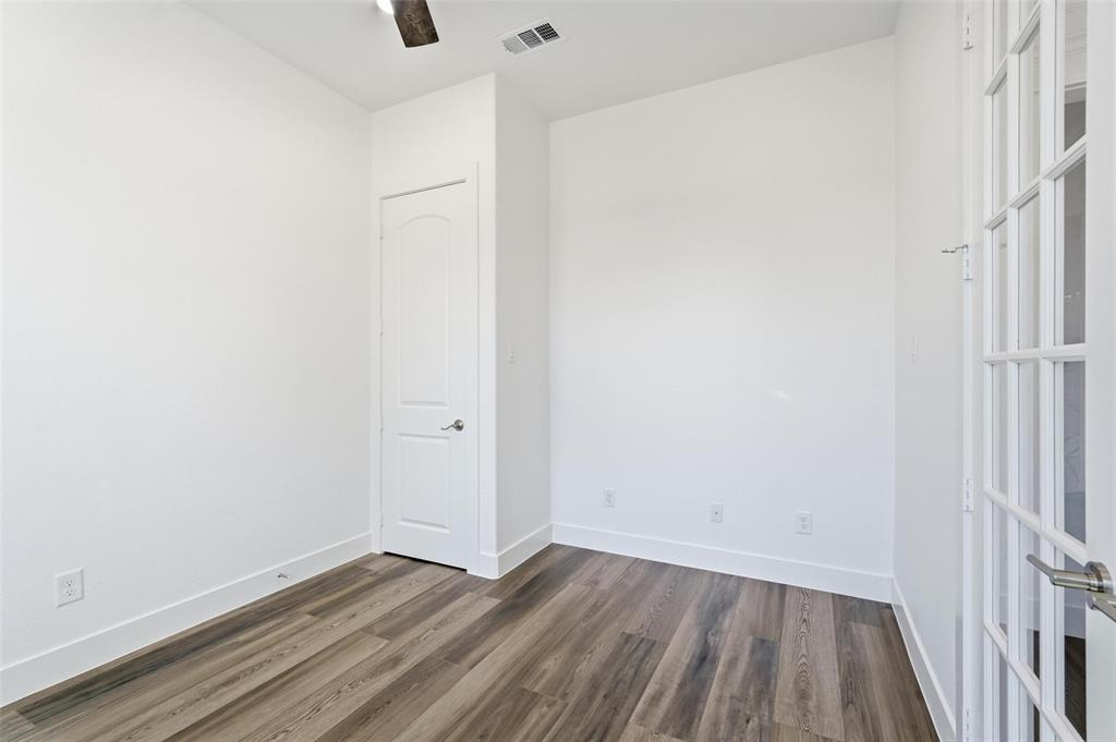 1110 Norris Street Commerce, TX 75428 - Photo 5 of 40 a view of an empty room with wooden floor and a window