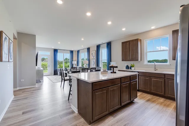 a kitchen with a sink cabinets and wooden floor