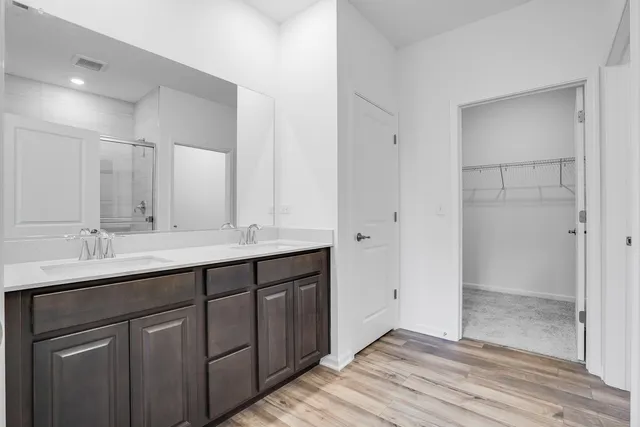a bathroom with a double vanity sink and mirror
