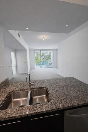 a kitchen with granite countertop a sink a counter top space and a granite counter tops