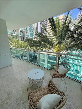 a view of a patio with couches chairs and potted plants