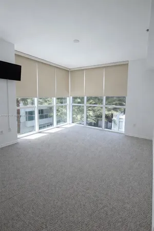 a view of an empty room with a large window