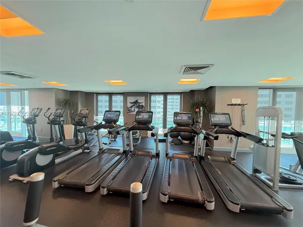 a gym room with lots of gym equipment